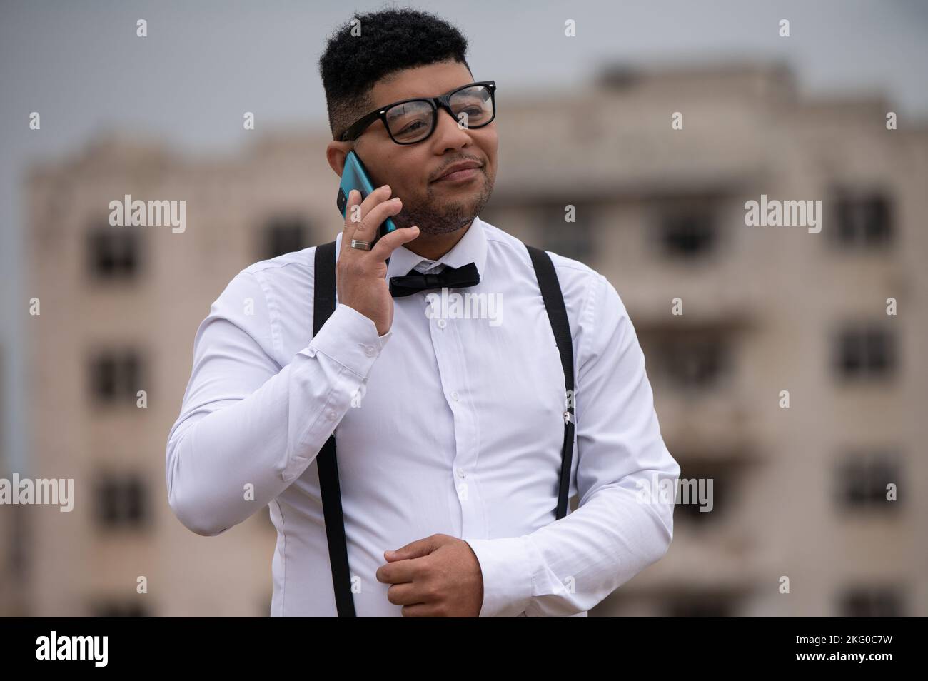 Young man seen using his cellphone Stock Photo