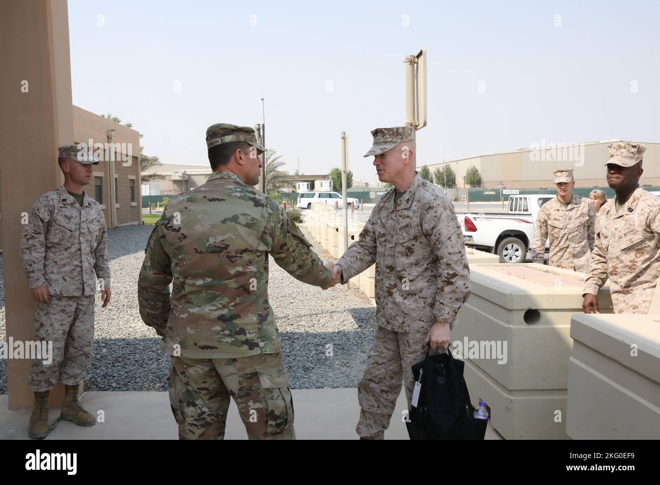 U.S. Army Col. Martin A. Wohlgemuth, commander, Area Support Group - Kuwait, shakes hands with U.S. Marine Corps Maj. Gen. Paul J. Rock Jr., commander, U.S. Marine Corps Forces, Central Command, at Camp Arifjan, Kuwait, Oct. 19. 2022. Stock Photo