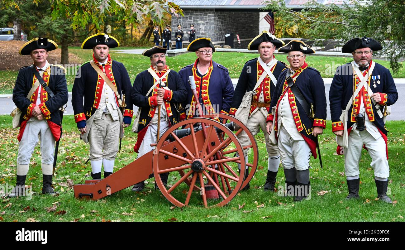 Members of the Saratoga Battle Chapter of the Sons of the Revolution pose for a photo, with their cannon, prior to the dedication of a memorial stone for Private Oliver Barrett at the Saratoga National Cemetery on October 19, 2022.  Barrett volunteered as a Minuteman and died serving under the 10th Massachusetts Regiment in the Battle of Saratoga on October 7, 1777, at 51 years of age. Barrett lies in an unmarked grave on the Saratoga Battlefield and was honored with a memorial stone at the ceremony. Stock Photo