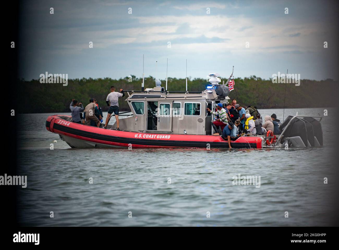 A Coast Guard Station Key West law enforcement crew transports Cuban migrants off Key West