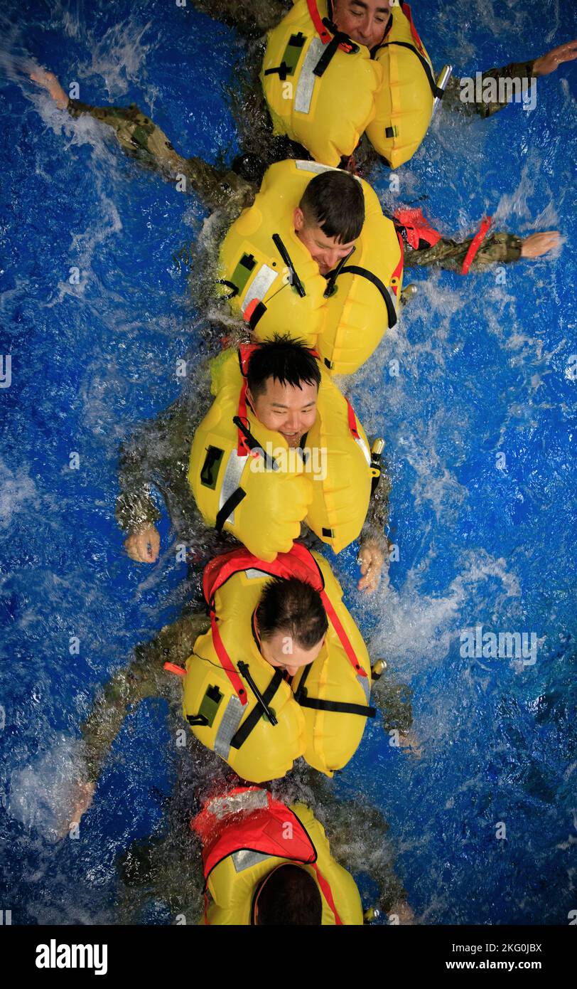 Soldiers from the 12th Combat Aviation Brigade swim towards a life raft ...