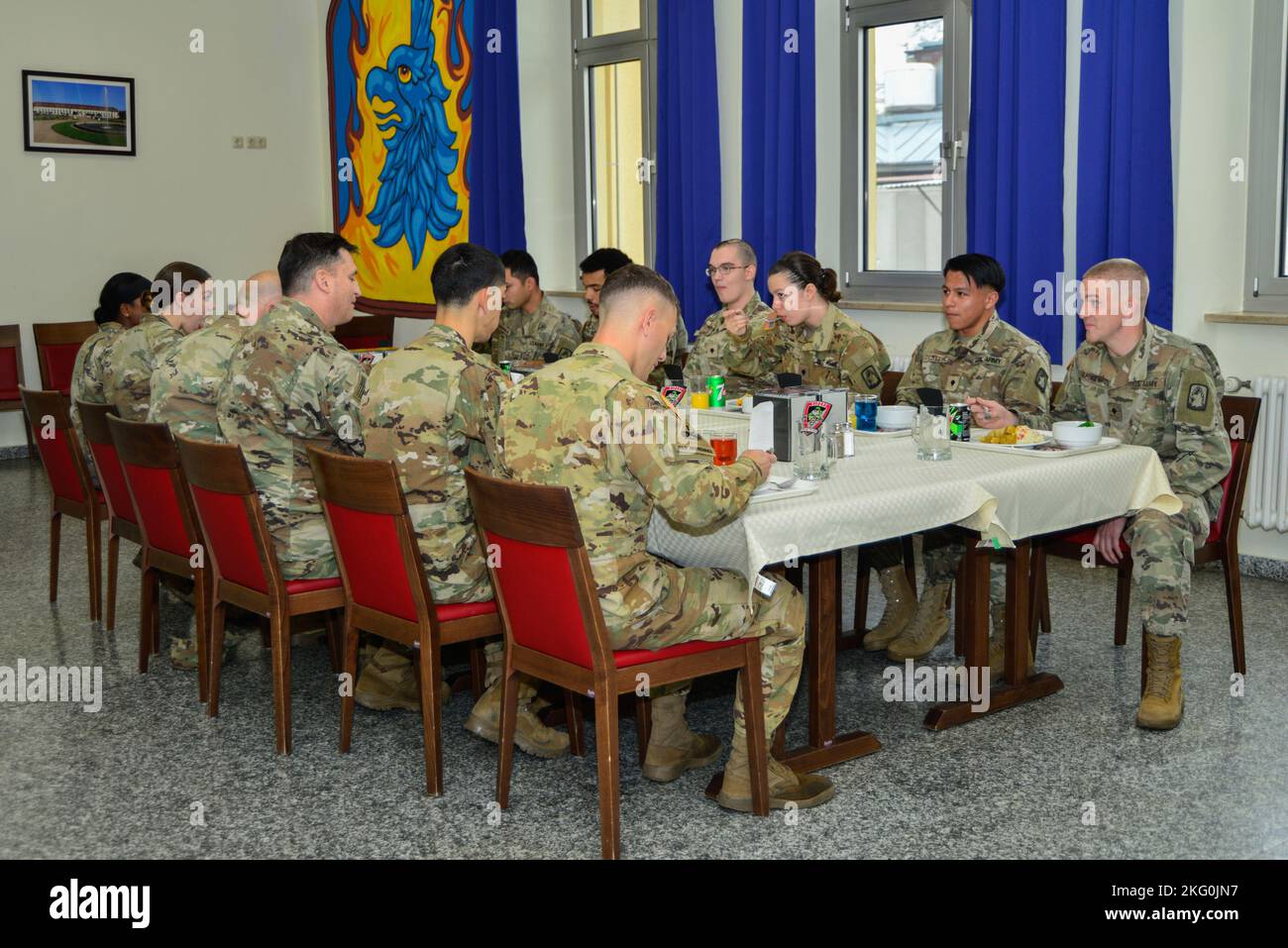 Command Sgt. Maj. Christopher Prosser, deputy command sergeant major forward, V Corps and Maj. Gen. David Womack, deputy commanding general-maneuver, had lunch with Soldiers assigned to the 12th Combat Aviation Brigade at the Katterbach Army Airfield, Germany, (date). 12 CAB is among other units assigned to V Corps, America's Forward Deployed Corps in Europe. They work alongside NATO Allies and regional security partners to provide combat-ready forces, execute joint and multinational training exercises, and retain command and control for all rotational and assigned units in the European Theate Stock Photo