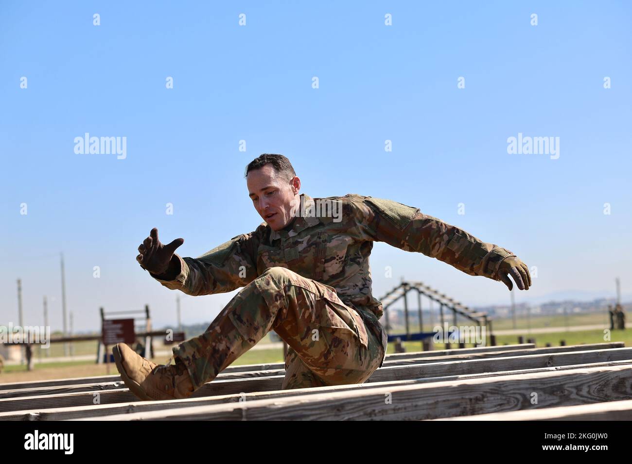 Master Sgt. Joseph Cole negotiates the high hurdle obstacle at the Camp ...