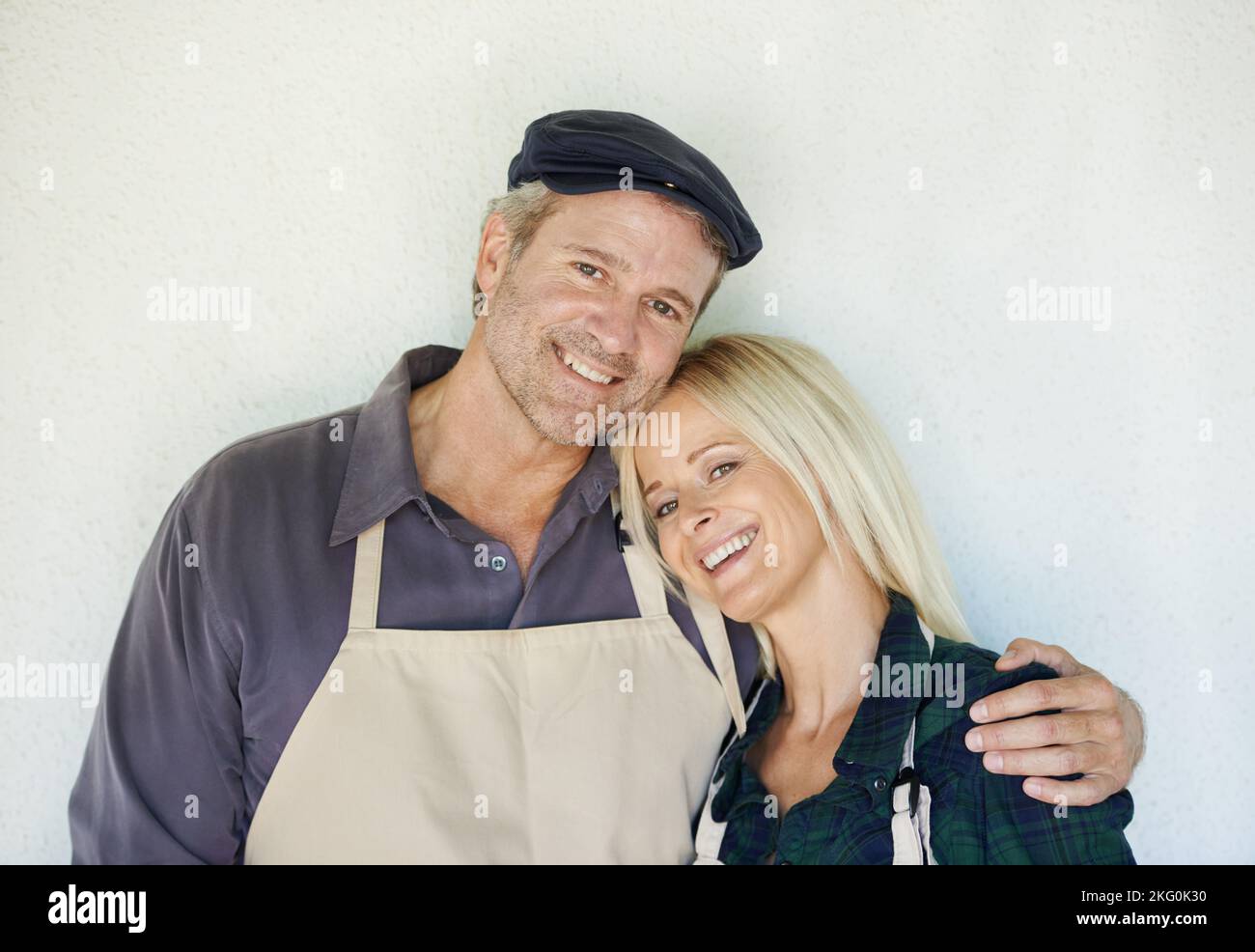 Two of a kind. A farmer and his wife standing in front of a wall Stock ...