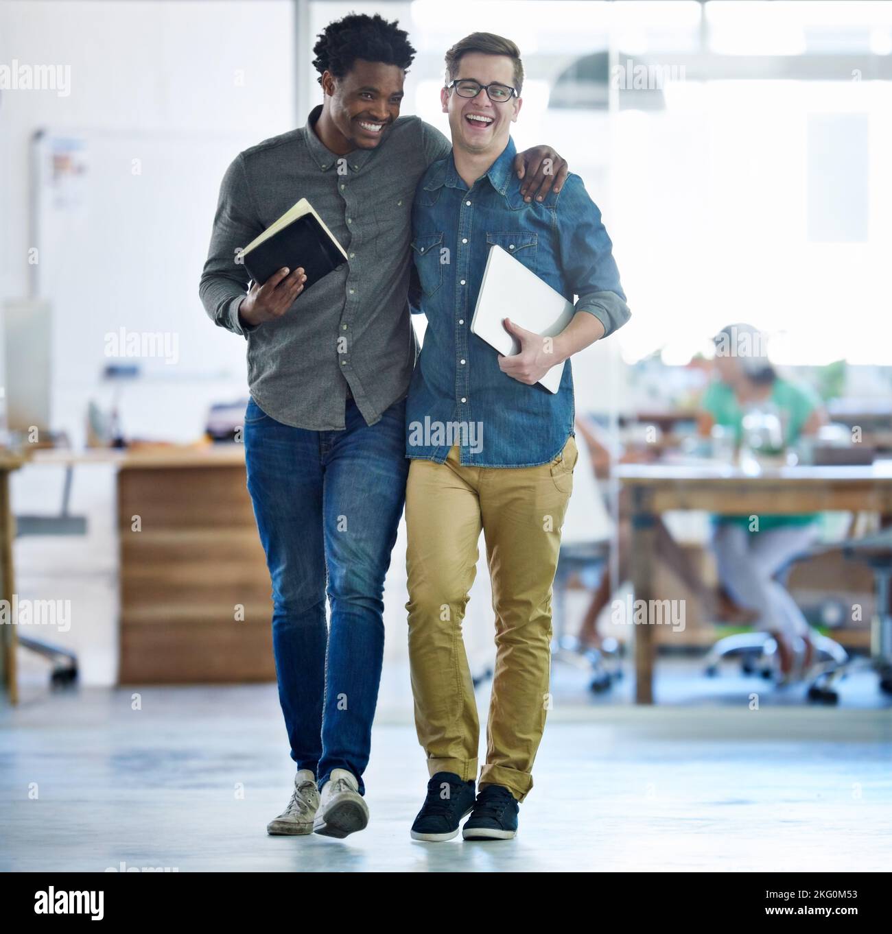 Theyve aced another project. a two young businessmen walking arm in arm