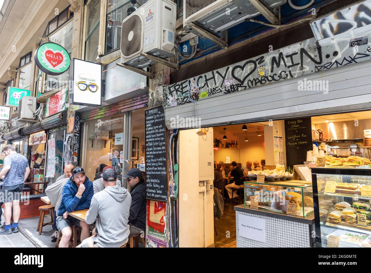 Melbourne laneway male friends chat at a cafe in Centre Place laneway