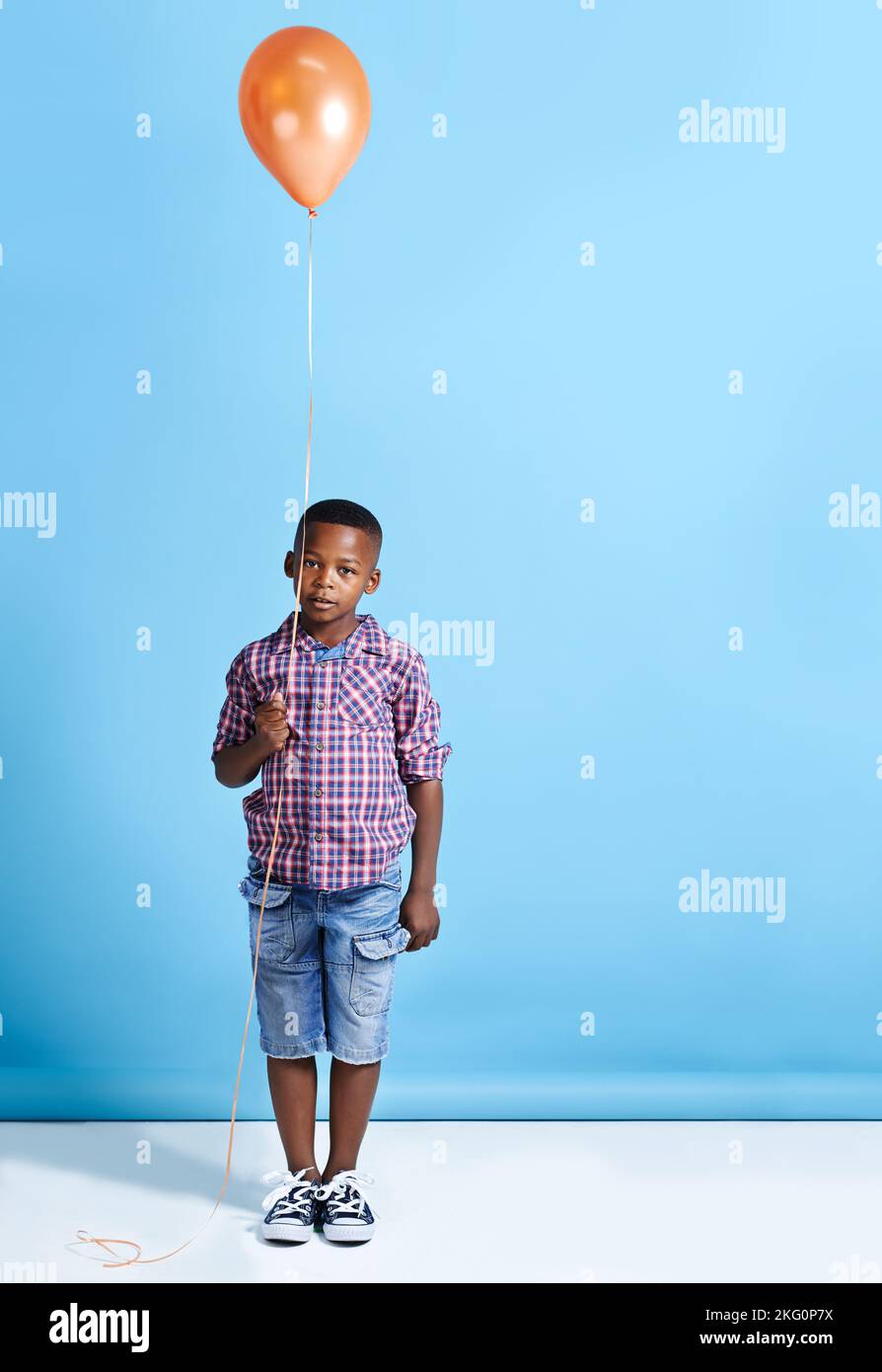 Child holding a balloon hi-res stock photography and images - Alamy