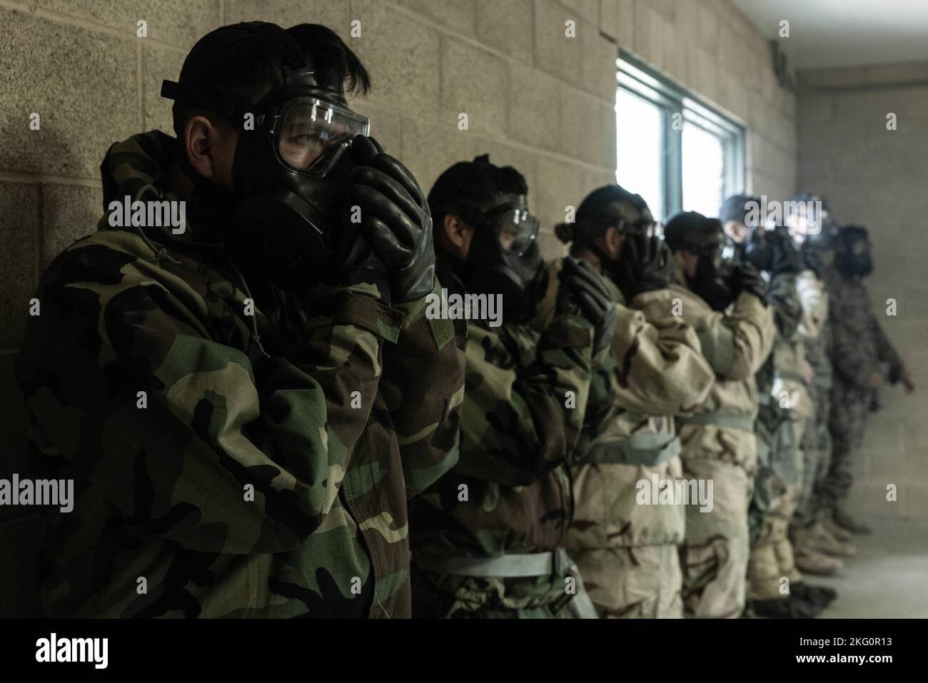 U.S. Marines with Headquarters Battalion, 1st Marine Division, clear their masks of chlorobenzalmalononitrile gas, commonly known as CS gas, during chemical, biological, radiological and nuclear defense training at Marine Corps Base Camp Pendleton, California, Oct. 20, 2022. CBRN training is conducted annually to ensure Marines know how to use their protective gear in the event of a chemical attack. Stock Photo