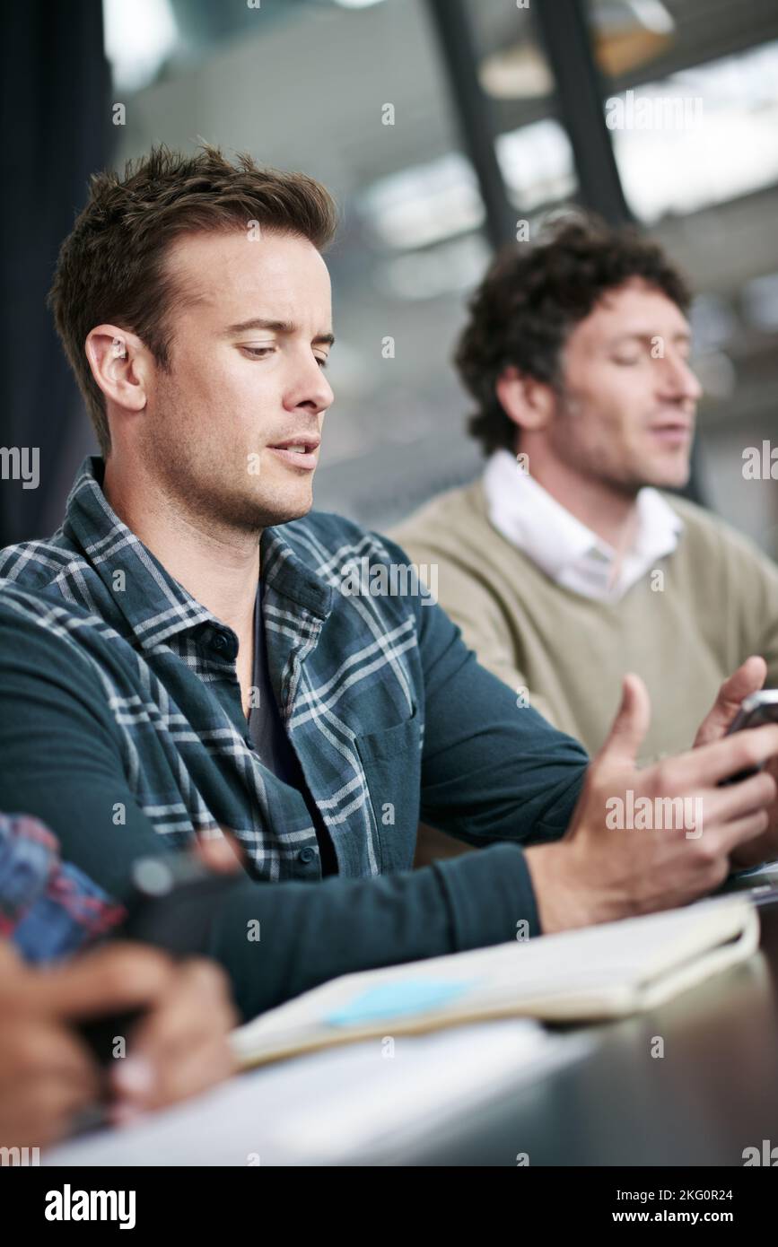Using the internet to find the answers. a coworkers in a business meeting. Stock Photo