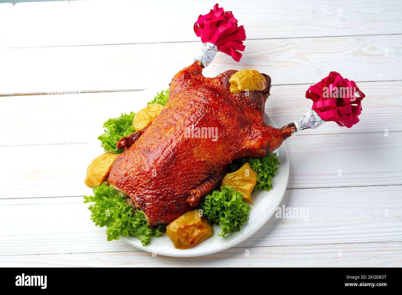 Oven baked duck with herbs and fruits on white plate Stock Photo - Alamy