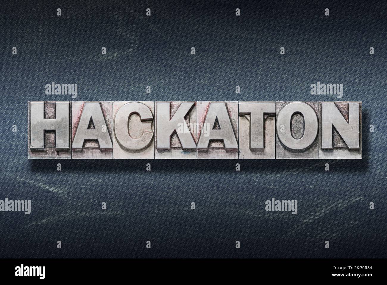 hackaton word made from metallic letterpress on dark jeans background Stock Photo