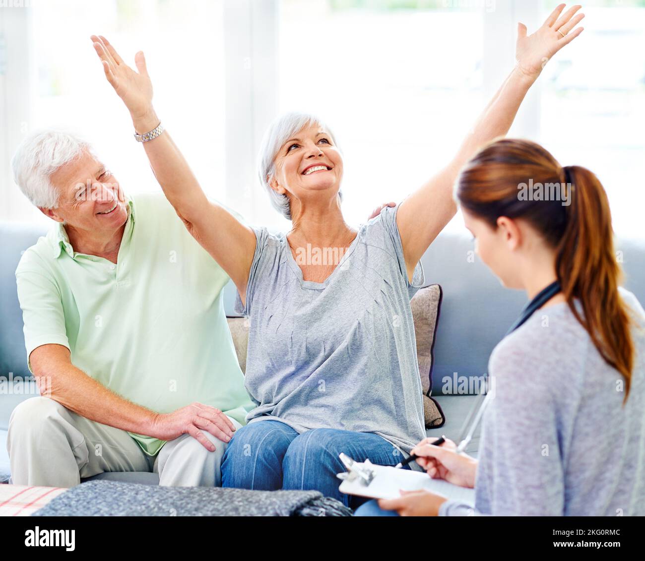 Overjoyed at her test results. A doctor explaining positive test results to an overjoyed senior patient and her husband. Stock Photo