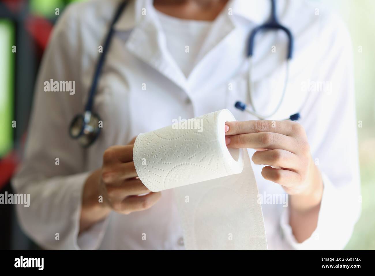 Female doctor hands demonstrates toilet paper roll Stock Photo Alamy