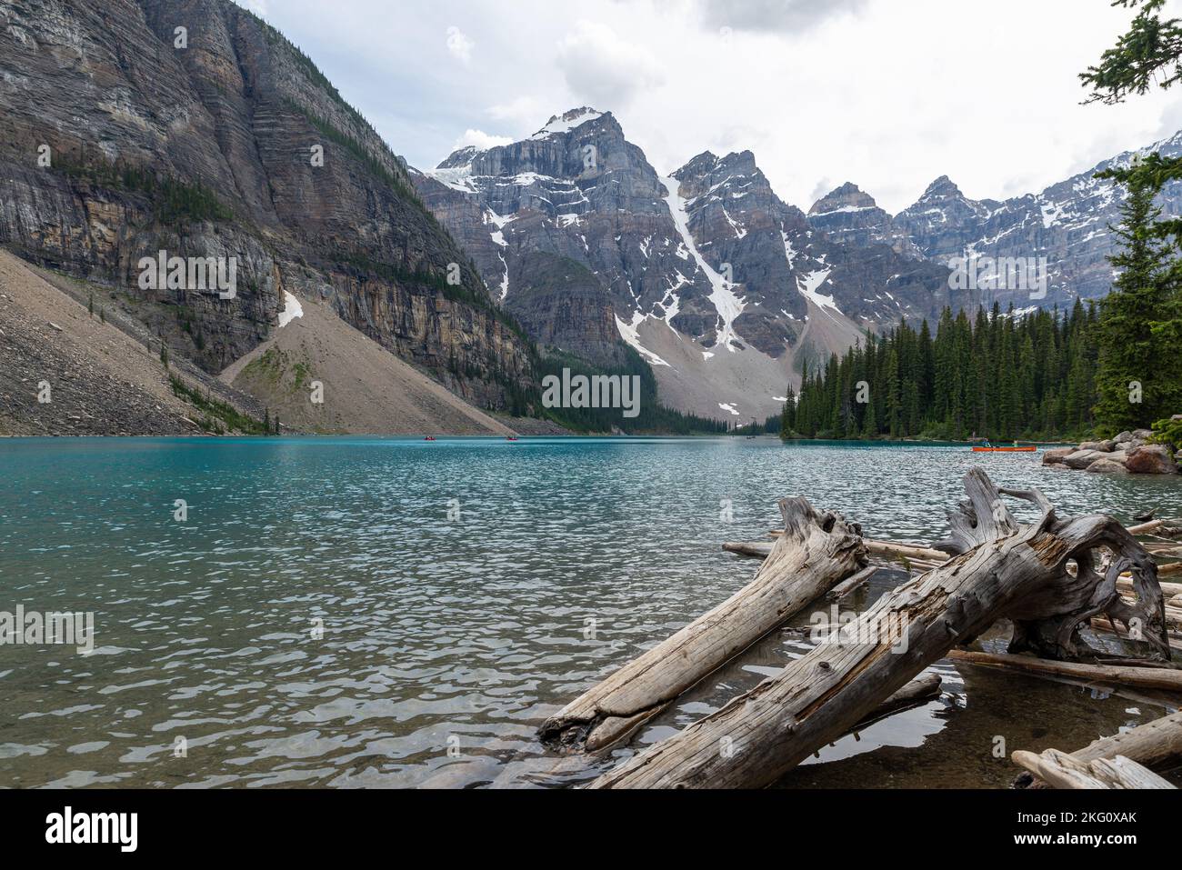 An aerial view of lake surrounded by dense trees and mountains Stock ...