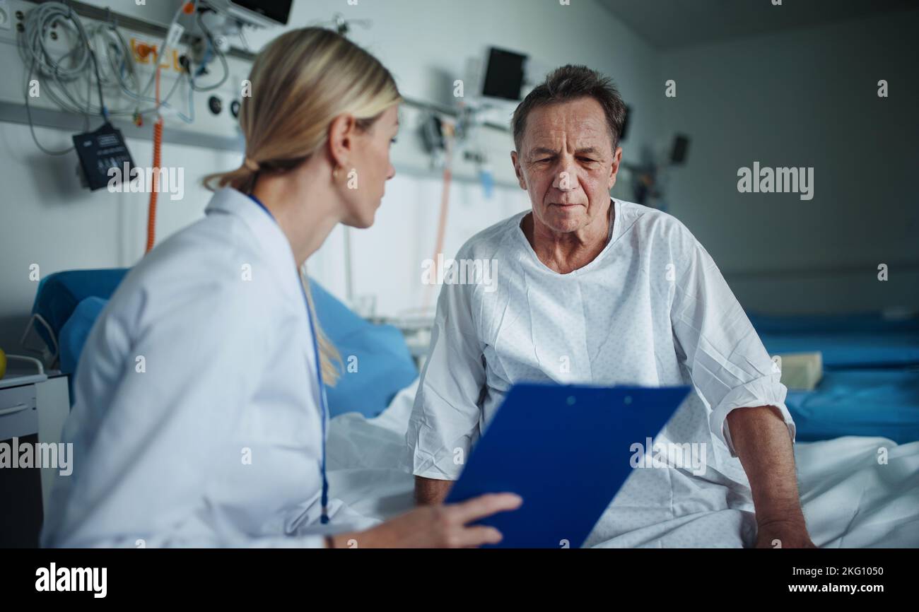 Young woman doctor explaining diagnosis to her patient. Stock Photo
