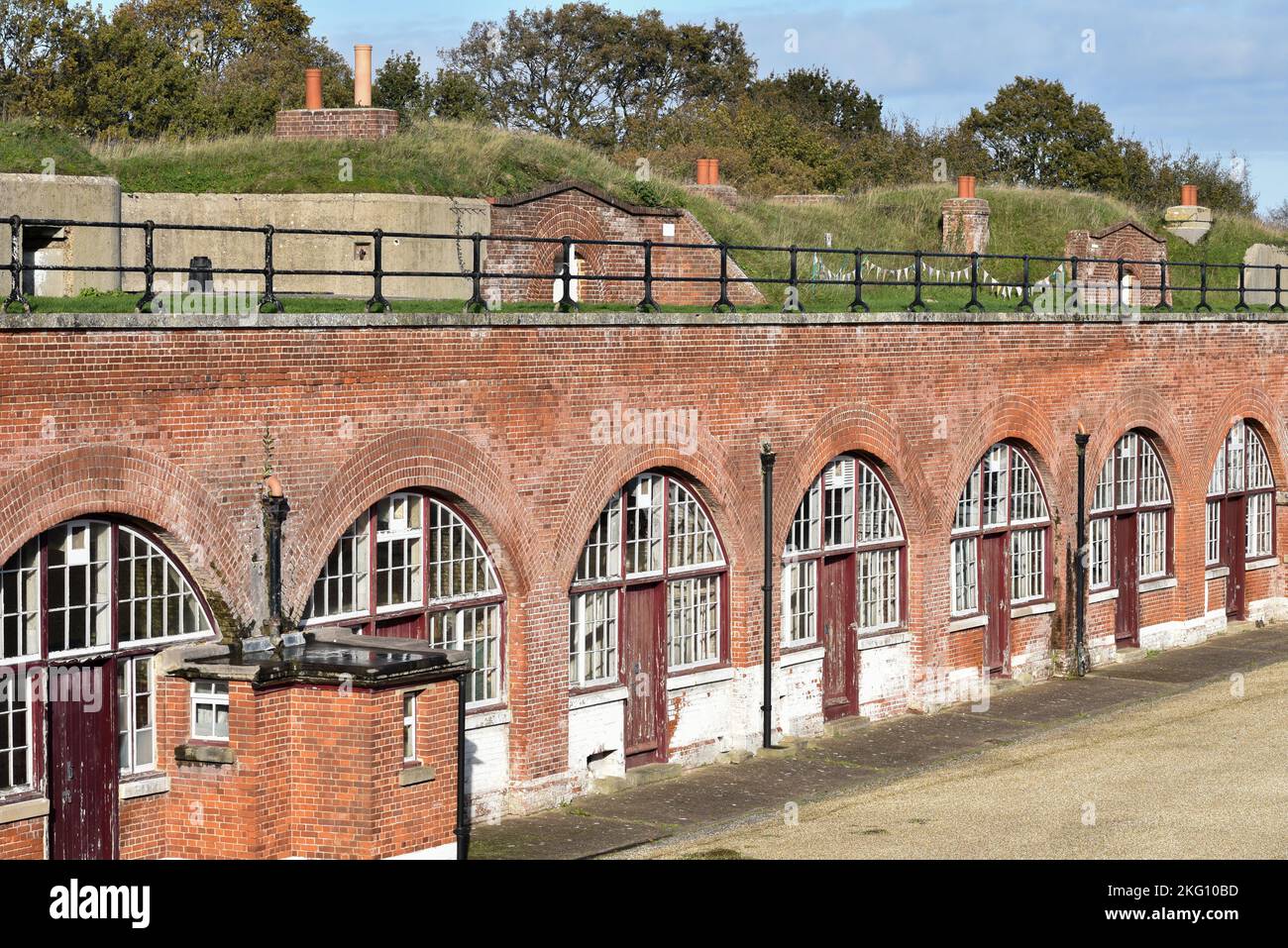 Inside Fort Brockhurst in Gosport, England, showing a row of troop quarters with arches and doors. Stock Photo
