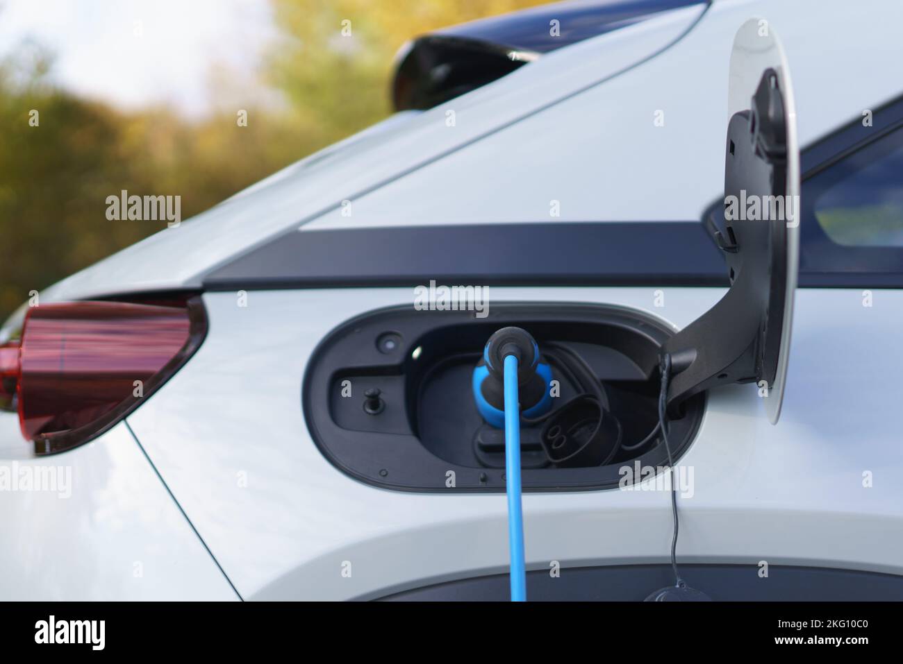 Charging an electric car,sustainable transportation concept. Stock Photo