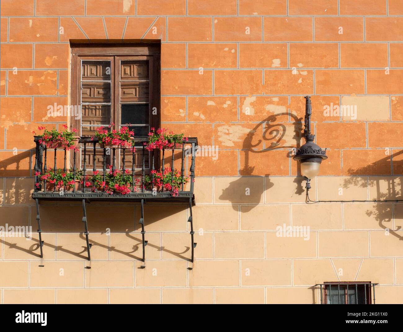Calle Ancha balconies. Historical building decorated with red flowers planters, Leon, Spain Stock Photo
