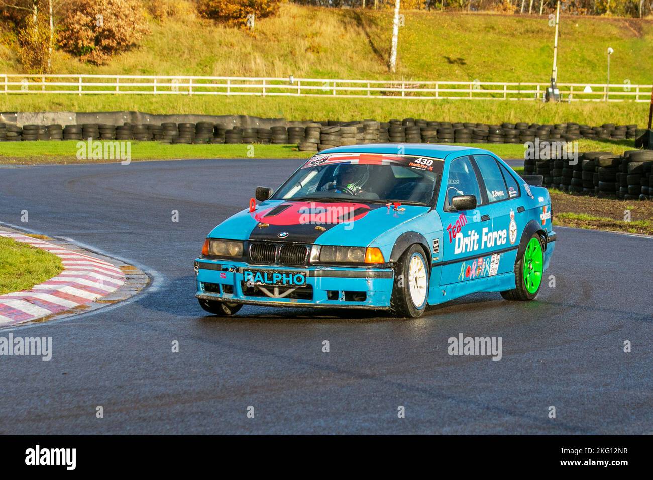 Blue BMW RALPHO Drift Force; Rear-wheel-drive car, driving on drift tracks and high-speed cornering on wet roads on a Three Sisters Drift Day in Wigan, UK Stock Photo