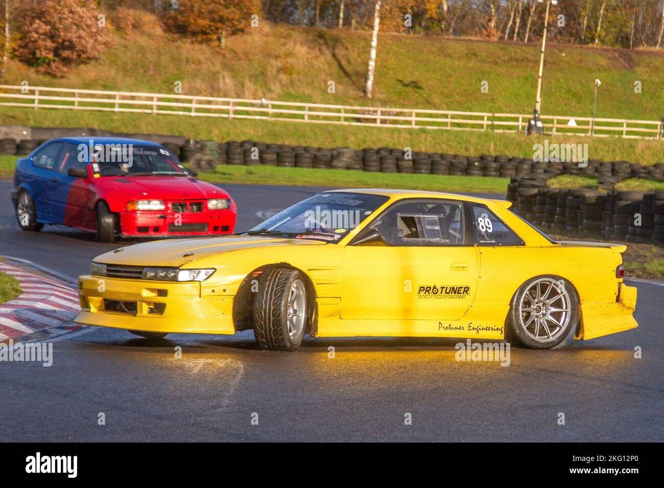 1000hp Lightning Yellow Nissan GT-R Skyline V-Spec - GTspirit Pro Tunes Engineering, Pro Tuner; Rear-wheel-drive car, driving on drift tracks and high-speed cornering on wet roads on a Three Sisters Drift Day in Wigan, UK Stock Photo