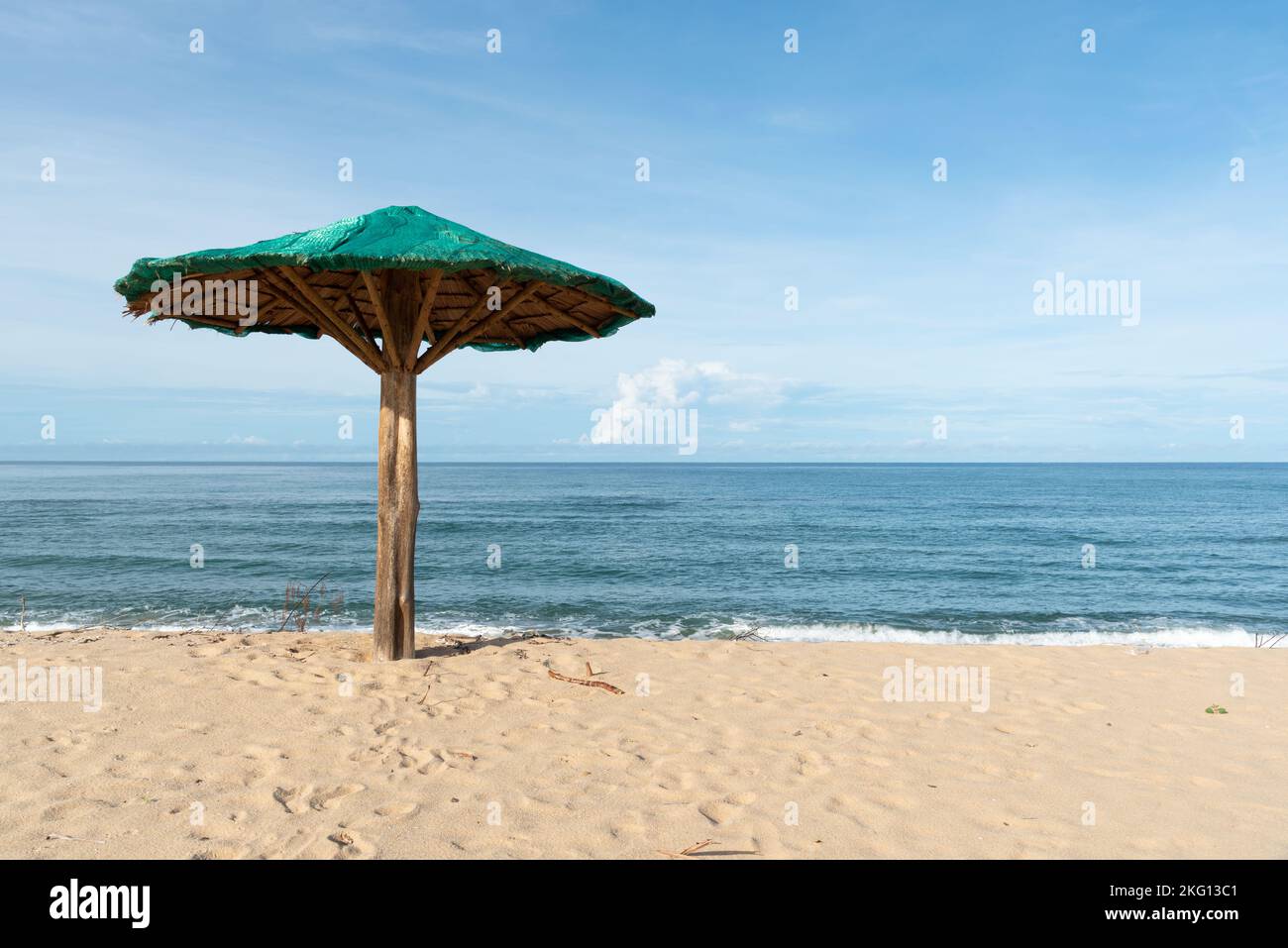A wooden umbrella on the beach in sunny day. Stock Photo