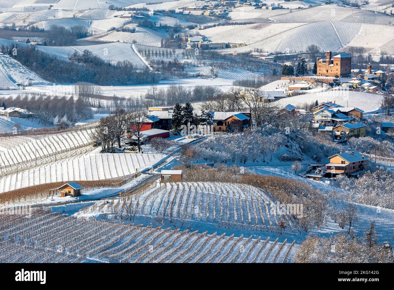 View from above of the small village among hills and vineyards covered with snow in Piedmont, Northern Italy. Stock Photo