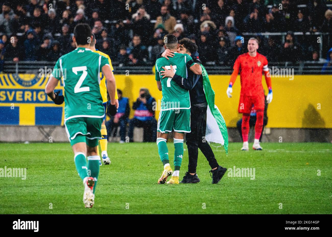 Malmoe, Sweden. 19th, November 2022. Riyad Mahrez (7) of Algeria seen with a fan who gained access to the pitch during the football friendly between Sweden and Algeria at Eleda Stadion in Malmoe. (Photo credit: Gonzales Photo - Joe Miller). Stock Photo