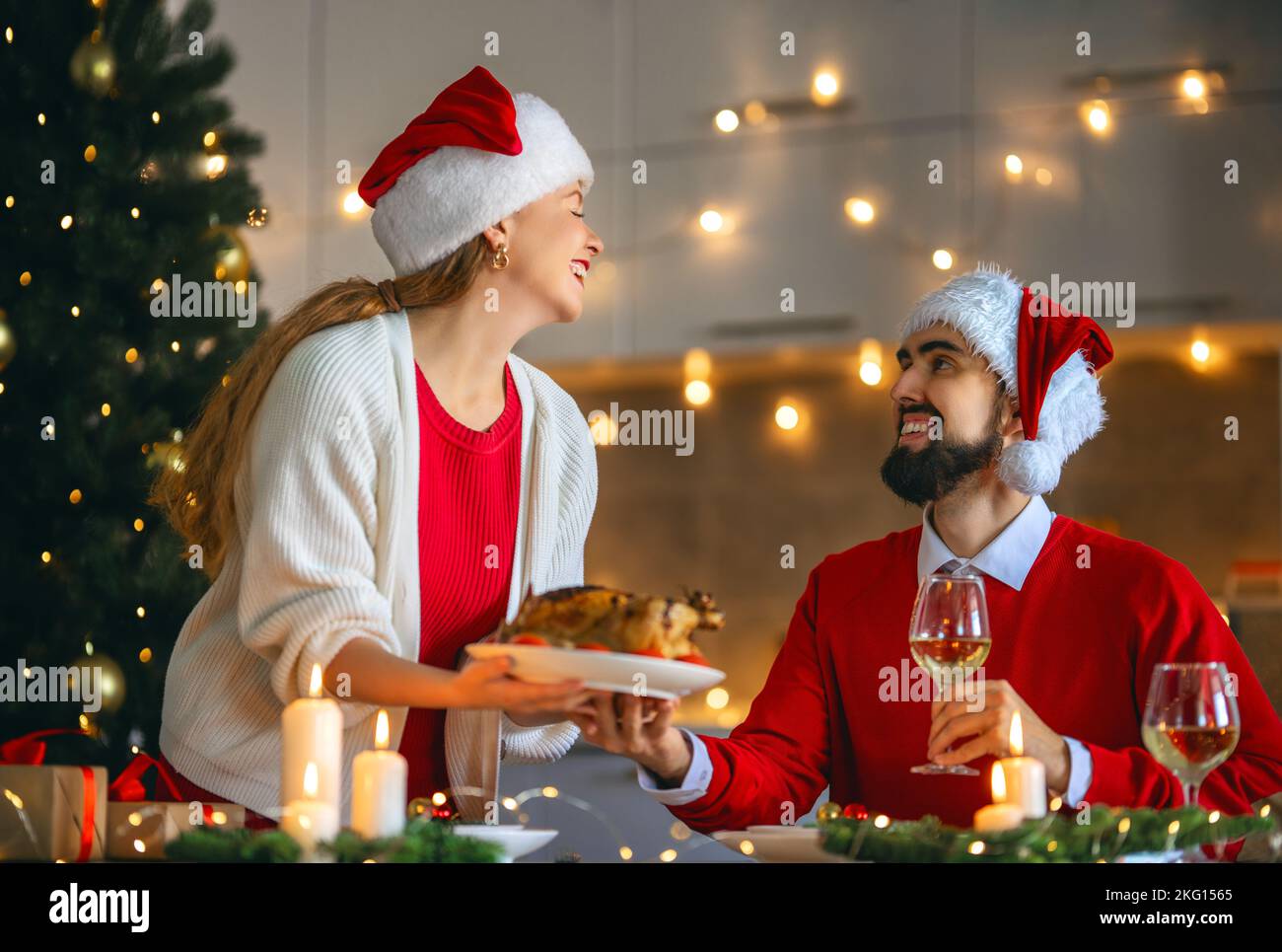 Merry Christmas. Happy loving couple is having dinner at home. Celebration holiday and 