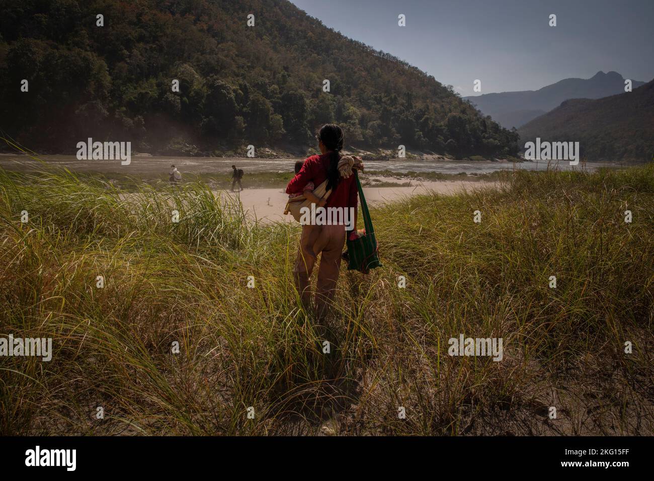 A family flees towards the border with Thailand in Kayah (Karenni) State, eastern Myanmar, south east Asia. Stock Photo