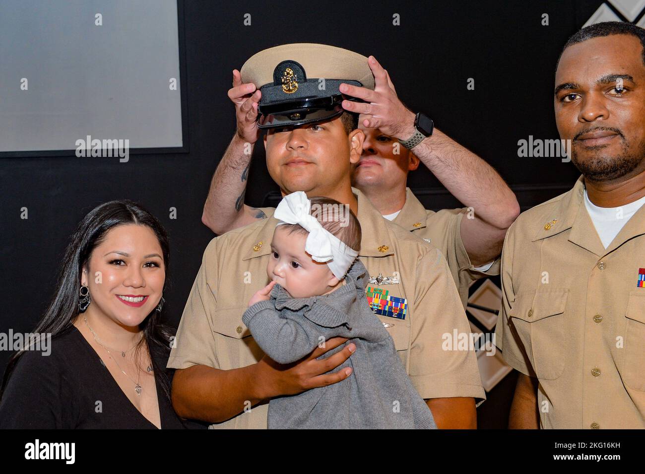 U.S. Navy Chief Machinist’s Mate Juan Castillomorales, from Dallas, assigned to the aircraft carrier USS John C. Stennis (CVN 74), has his cover placed by his family and fellow chiefs during a chief petty officer pinning ceremony at the Coastal Virginia Church, in Norfolk, Virginia, Oct. 21, 2022. The John C. Stennis is in Newport News Shipyard working alongside NNS, NAVSEA and contractors conducting Refueling and Complex Overhaul as part of the mission to deliver the warship back in the fight, on time and on budget, to resume its duty of defending the United States. Stock Photo