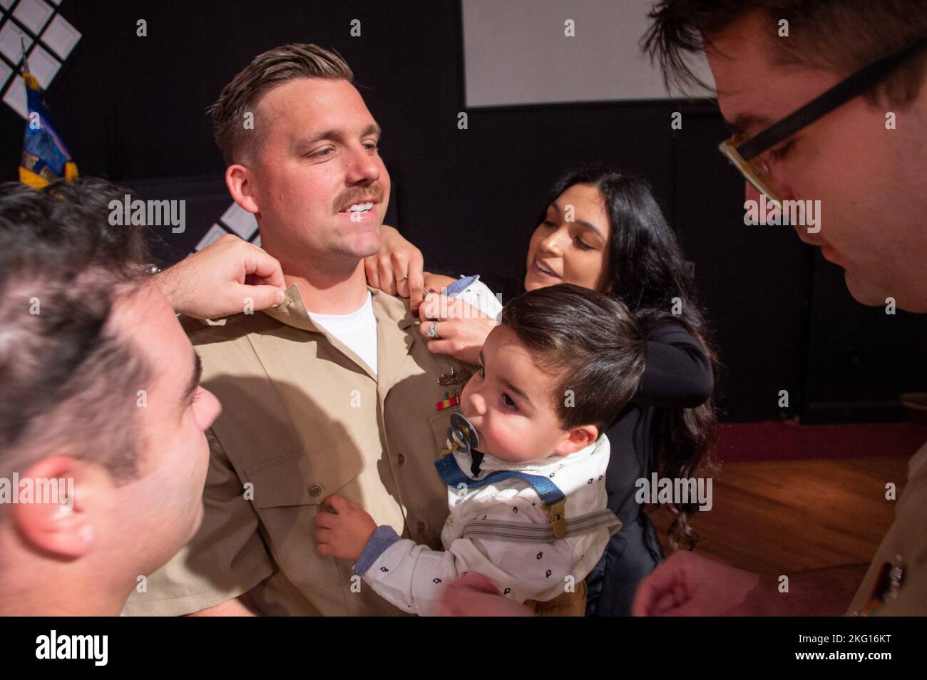 U.S. Navy Chief Machinist’s Mate (Nuclear) Matson Stillwell, from San Diego, assigned to the aircraft carrier USS John C. Stennis (CVN 74), has his new rank pinned on by his family and fellow chiefs during a chief petty officer pinning ceremony at the Coastal Virginia Church, in Norfolk, Virginia, Oct. 21, 2022. John C. Stennis is in Newport News Shipyard working alongside NNS, NAVSEA and contractors conducting Refueling and Complex Overhaul as part of the mission to deliver the warship back in the fight, on time and on budget, to resume its duty of defending the United States. Stock Photo