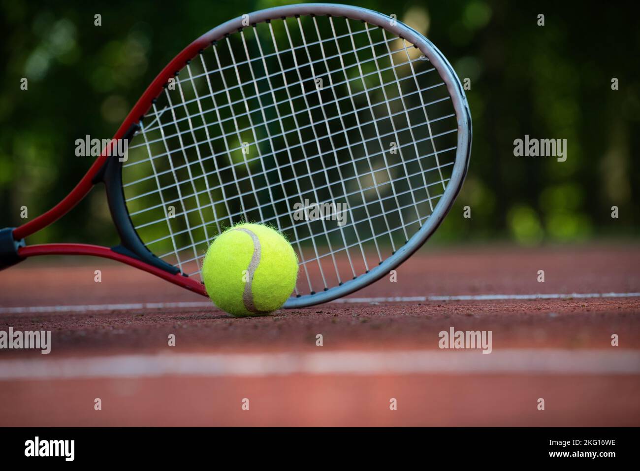 Low angle view tennis scene with yellow ball near racquet and white ...