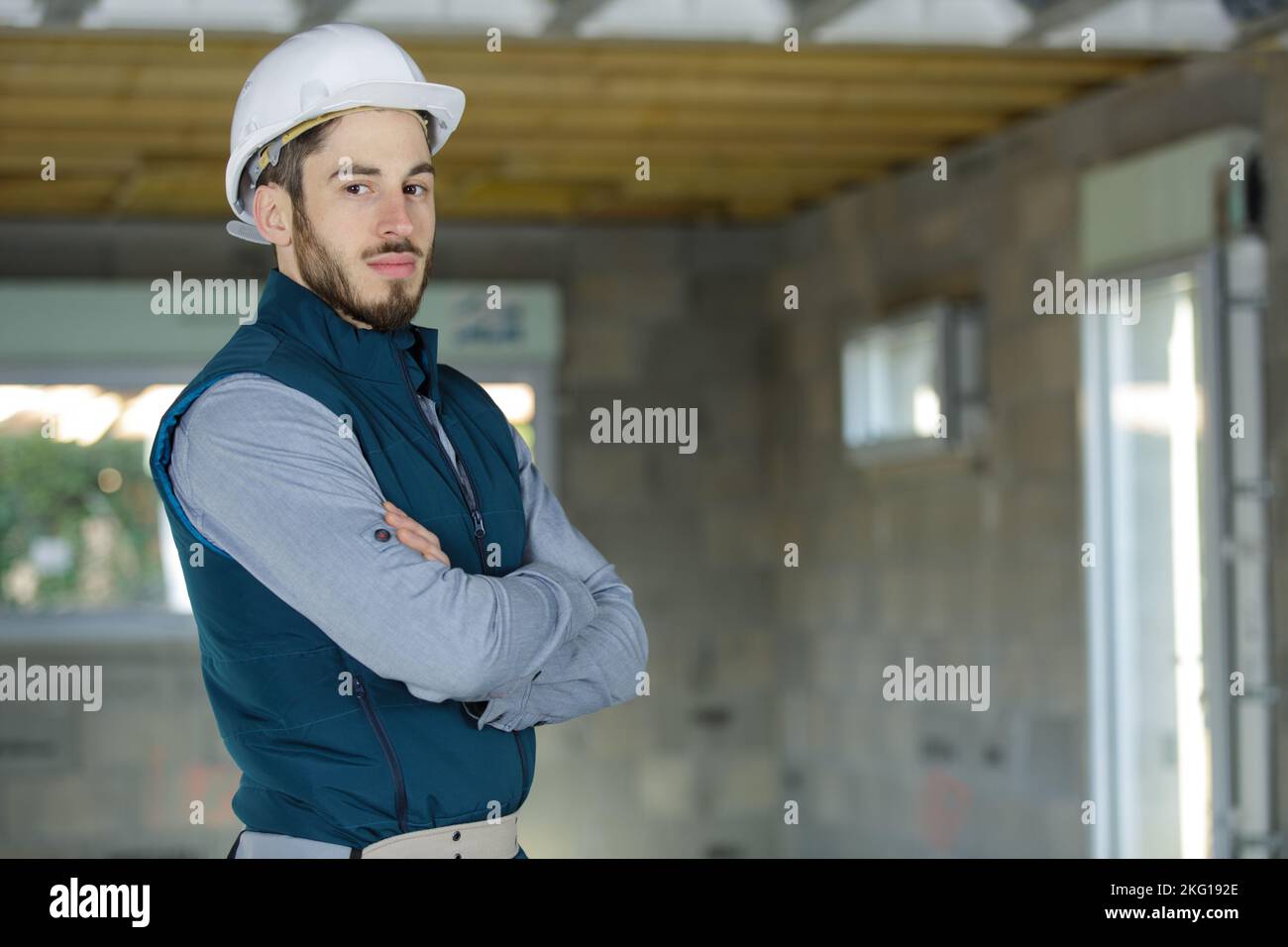 engineer in white hardhat standing on construction site Stock Photo