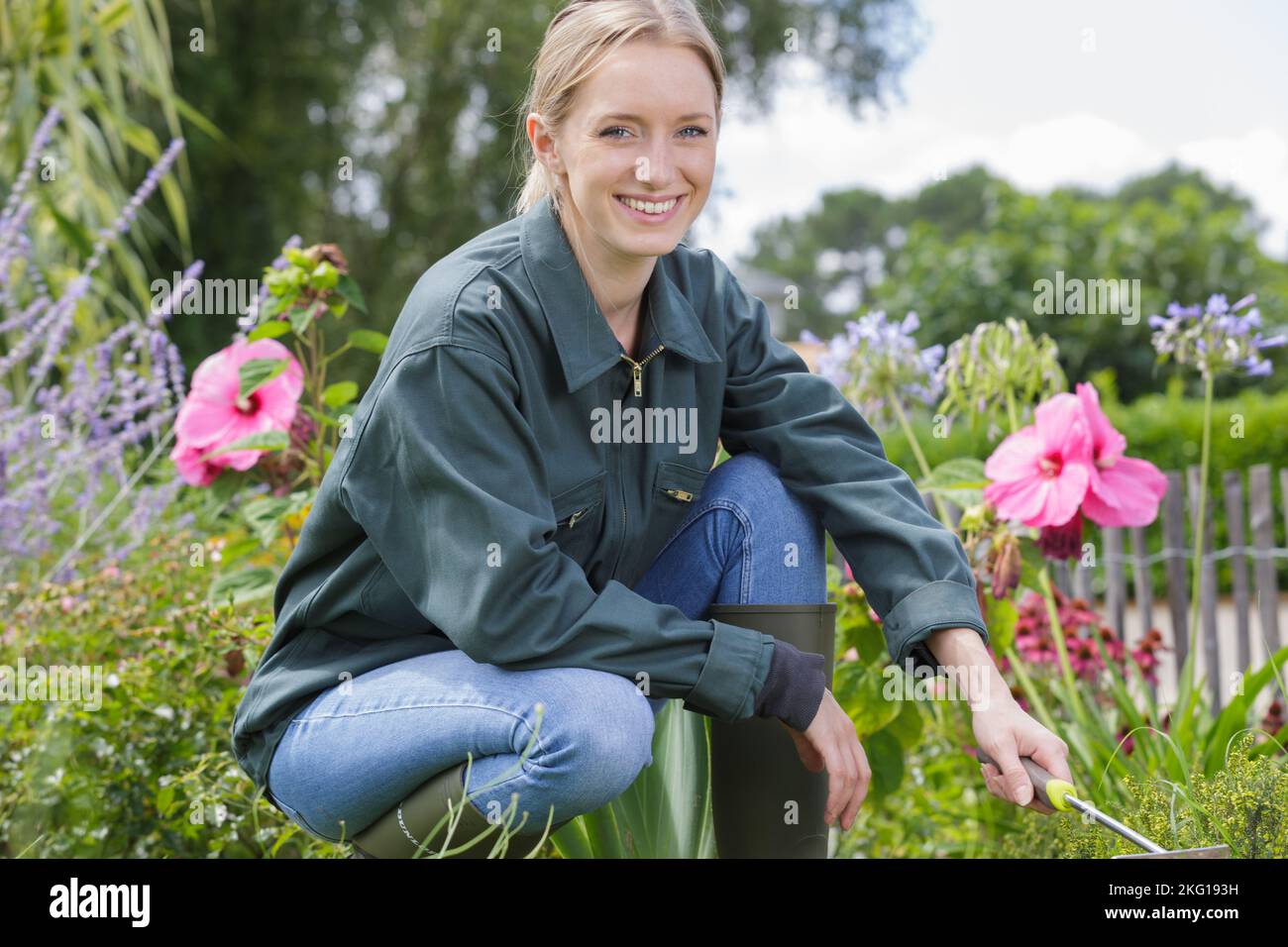 a happy young woman gardening Stock Photo - Alamy