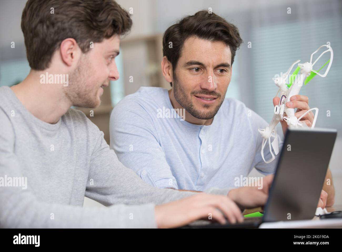 dad and son playing with toy drone Stock Photo - Alamy