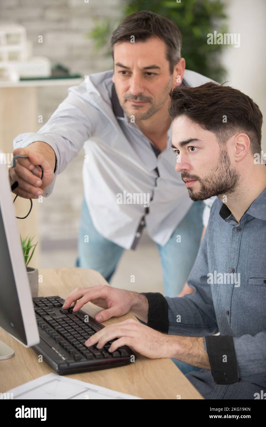 teacher and student working on computer Stock Photo