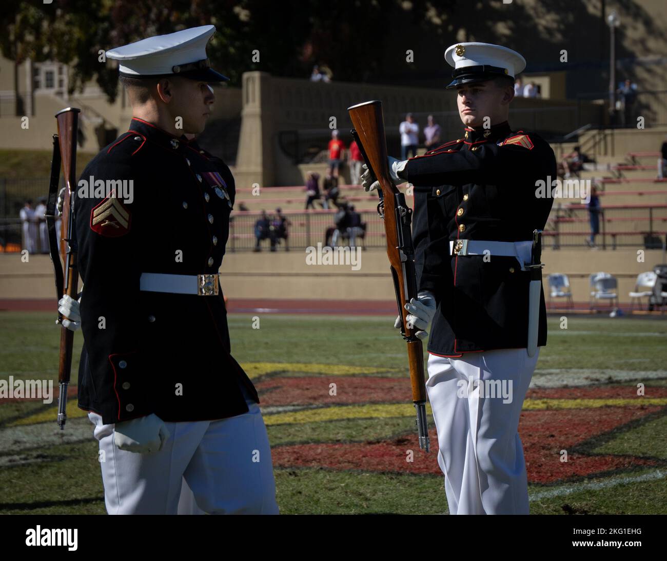 Cpl. Ty A. Blair and Cpl. Steven A. Almaguer, Marines with “The Silent Drill Platoon,” Marine Barracks Washington, perform their “rifle inspection” sequence during a Virginia Military Institute football game at Lexington, Va., Oct 22, 2022. The Marines performed for thousands of cadets and family members attending the game, demonstrating the professionalism of the United States Marine Corps. Stock Photo