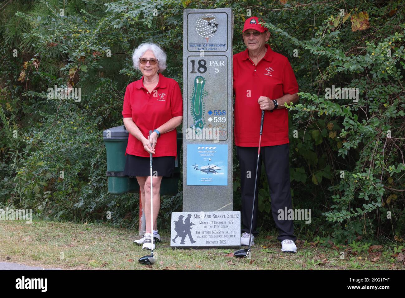 Retired U.S. Marine Corps Master Gunnery Sgt. Mike and Sharyl Sheftz stand beside their wedding anniversary plaque on the 18th hole on the Sound of Freedom Golf Course, Marine Corps Air Station Cherry Point, North Carolina, Oct. 23, 2022. Mike and Sharyl were the first couple to marry on the Sound of Freedom Golf Course and returned to celebrate their 50th marriage anniversary together with a round of golf. Stock Photo