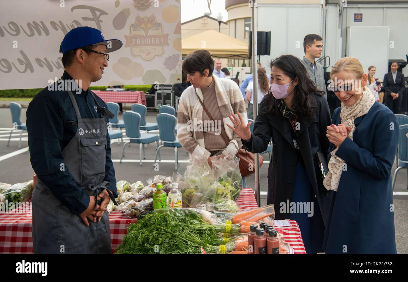 Farmers market participants speak with a local vendor at the first farmer’s market hosted by Yokota Air Base, Oct. 22, 2022. The goal of the farmers market is to increase access to produce and allow the base community to engage with the host nation and build bonds of trust between Yokota Air Base and the local community. Stock Photo