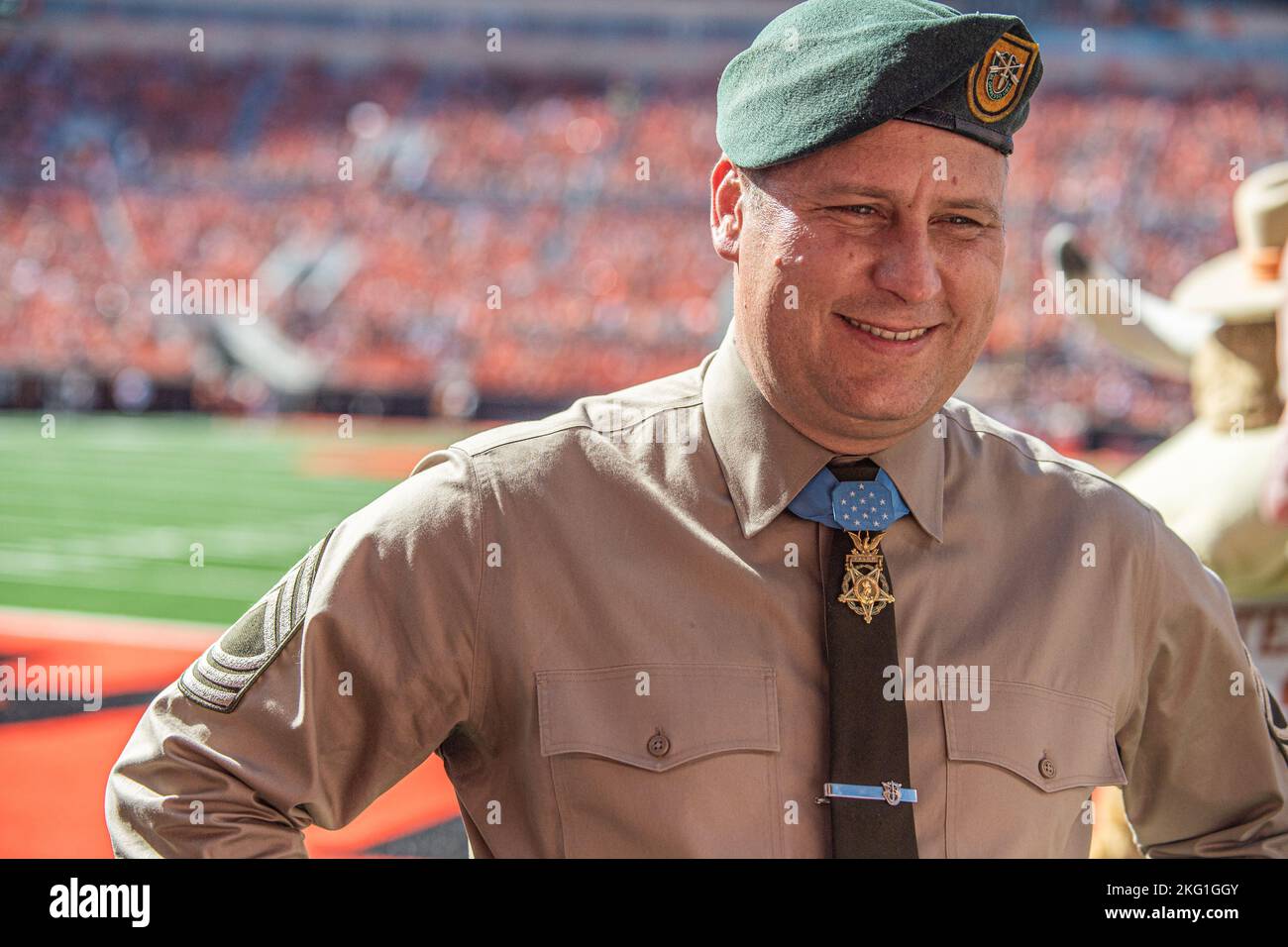 Master Sgt. Earl Plumlee, a Medal of Honor recipient, takes part in pre-game activities at the Oklahoma State University homecoming football game in Stillwater, Oklahoma, Oct. 22, 2022. Plumlee, a native Oklahoman, toured his home state Oct. 18-22. During his visit, Plumlee attended the Oklahoma State University homecoming football game and was honored as the Orange Power VIP of the game. (Oklahoma National Guard photo by Sgt. Anthony Jones) Stock Photo