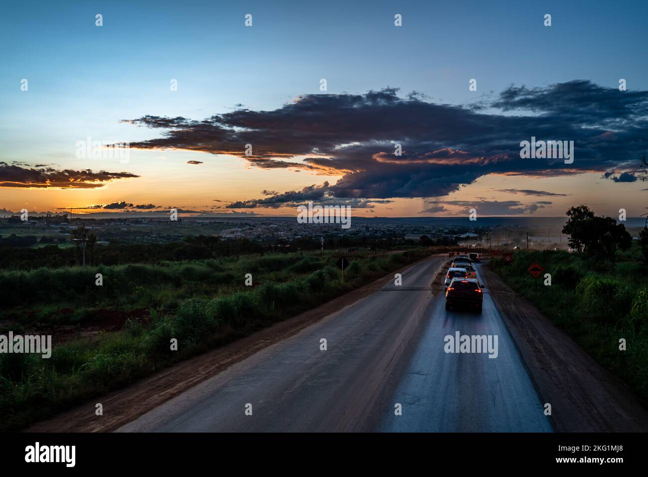 sunset over the road with cars Stock Photo
