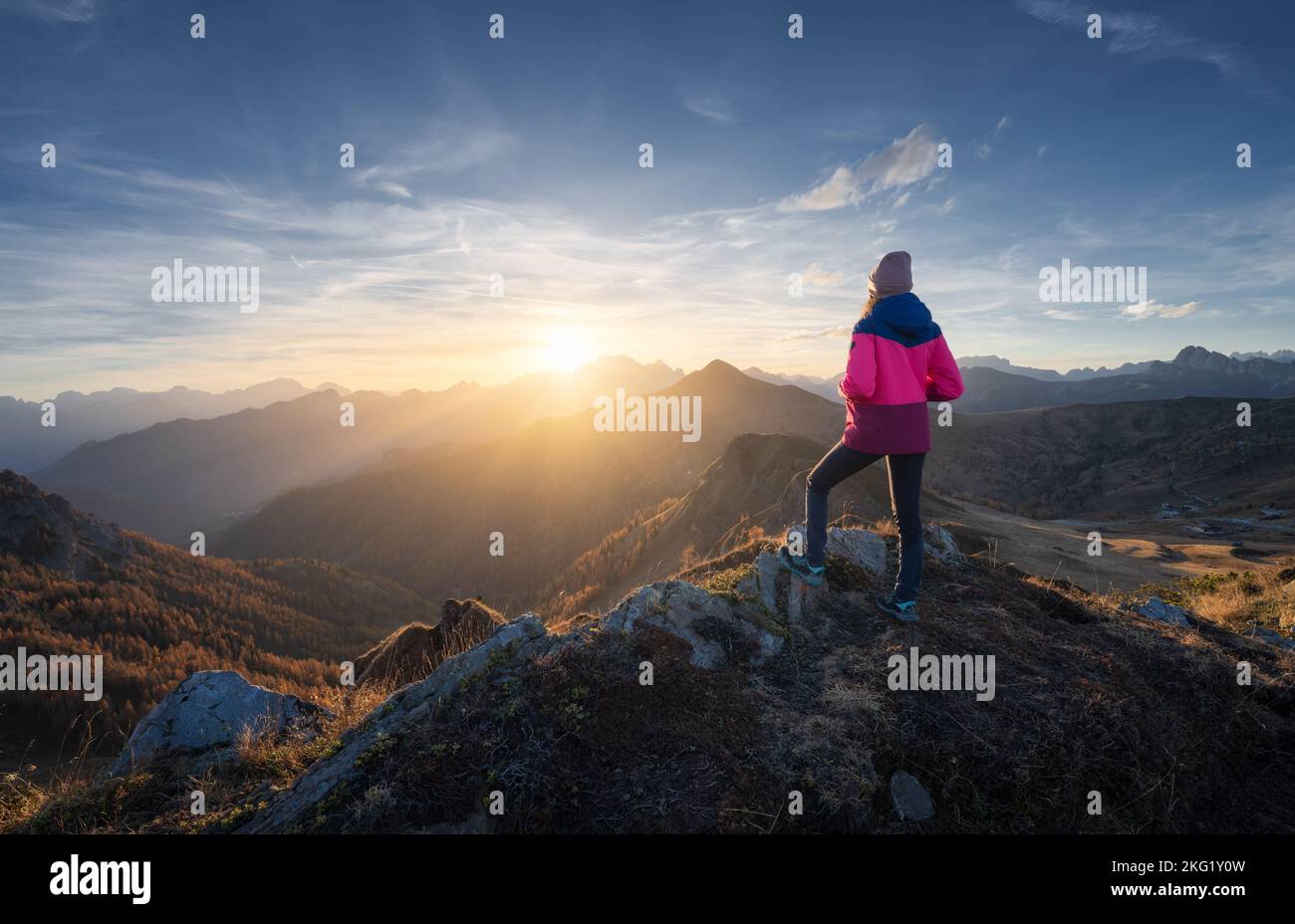 Young woman on mountain peak and beautiful mountains Stock Photo