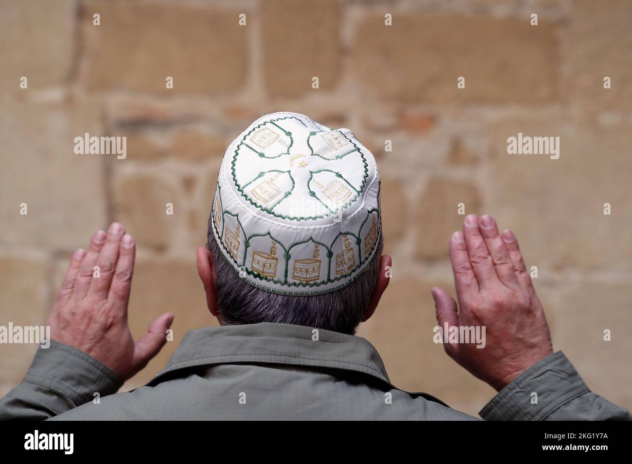 Back view of a muslim man praying with a kufi cap on head. Spain Stock
