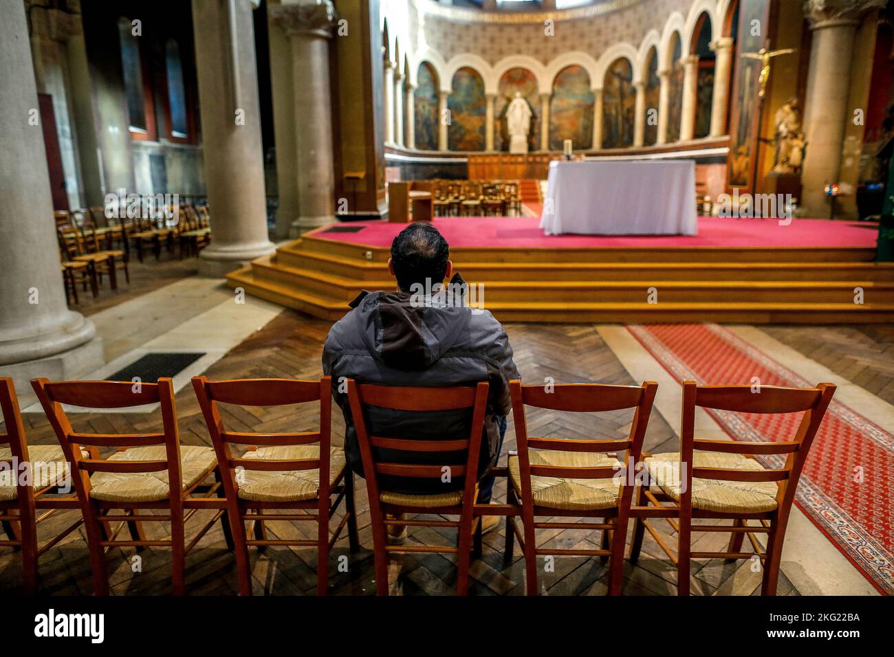 Former muslim converted to christianity praying in Notre-Dame de la Gare catholic church, Paris Stock Photo