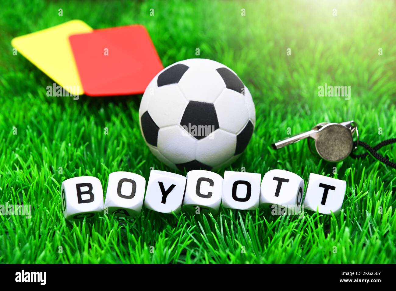 Football and red and yellow card, boycott of the football world cup, symbolic image Stock Photo