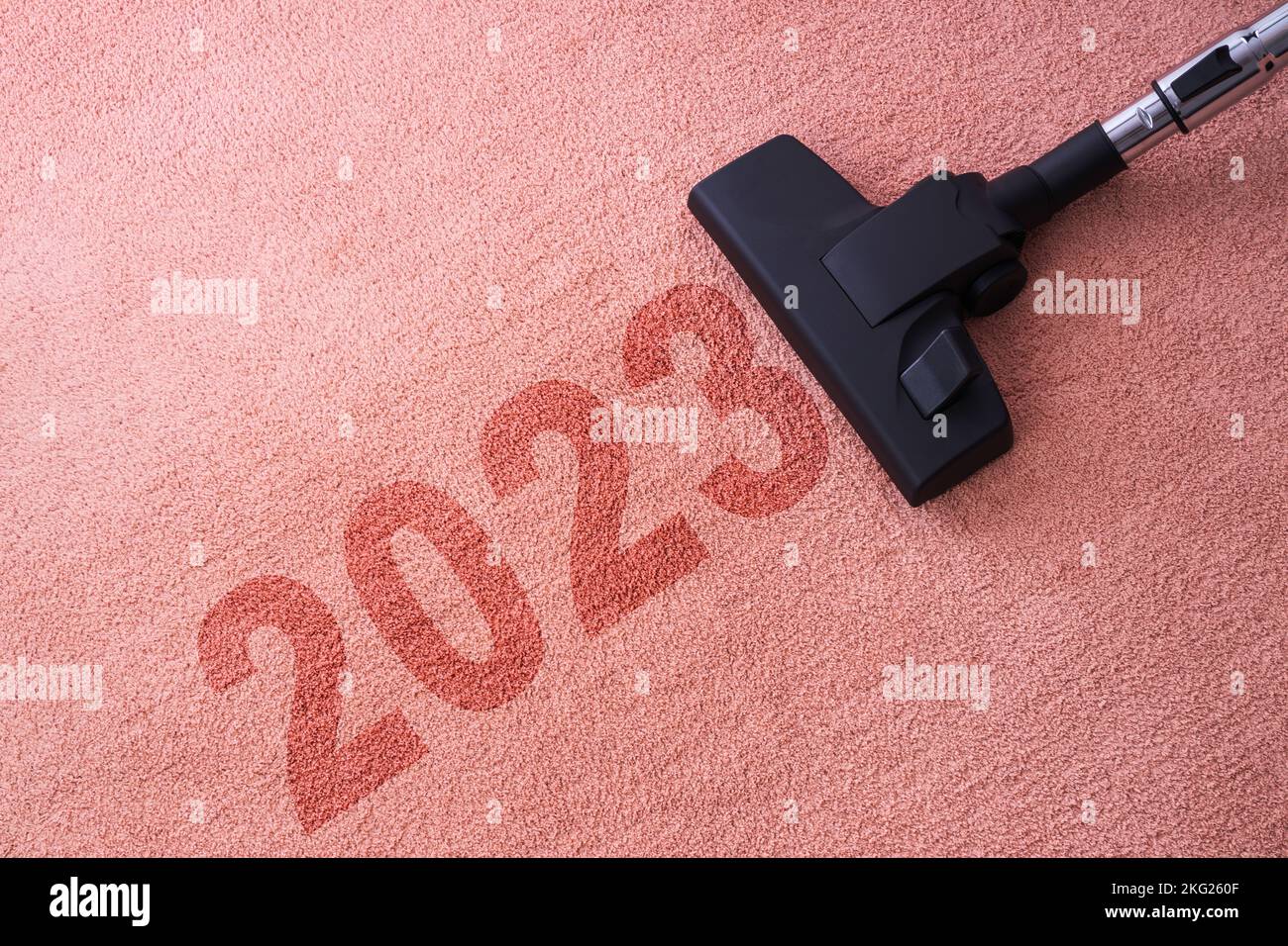 2023 New year home cleaning with vacuum cleaner and copy space for a text Stock Photo