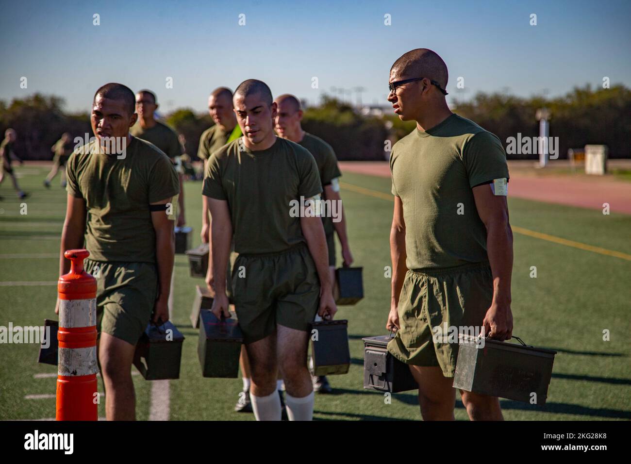 U.S. Marines Corps recruits with Fox Company, 2nd Recruit Training Battalion, carry ammunition cans during a physical training event at Marine Corps Recruit Depot San Diego, Oct. 25, 2022. Physical training is conducted regularly throughout recruit training to ensure physical readiness within the companies. Stock Photo