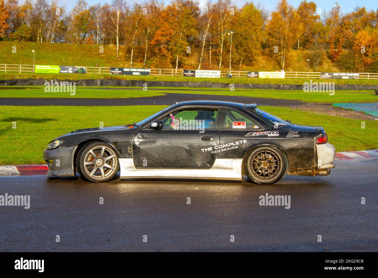 Nissan 200SX; Rear-wheel-drive car, driving on drift tracks and high-speed cornering on wet roads on a Three Sisters Drift Day in Wigan, UK Stock Photo
