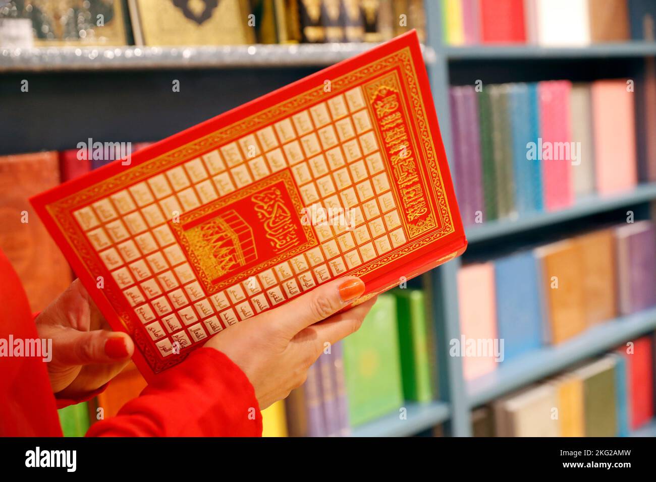 Muslim woman buying a Holy Quran in a bookstore. Dubai. United Arab