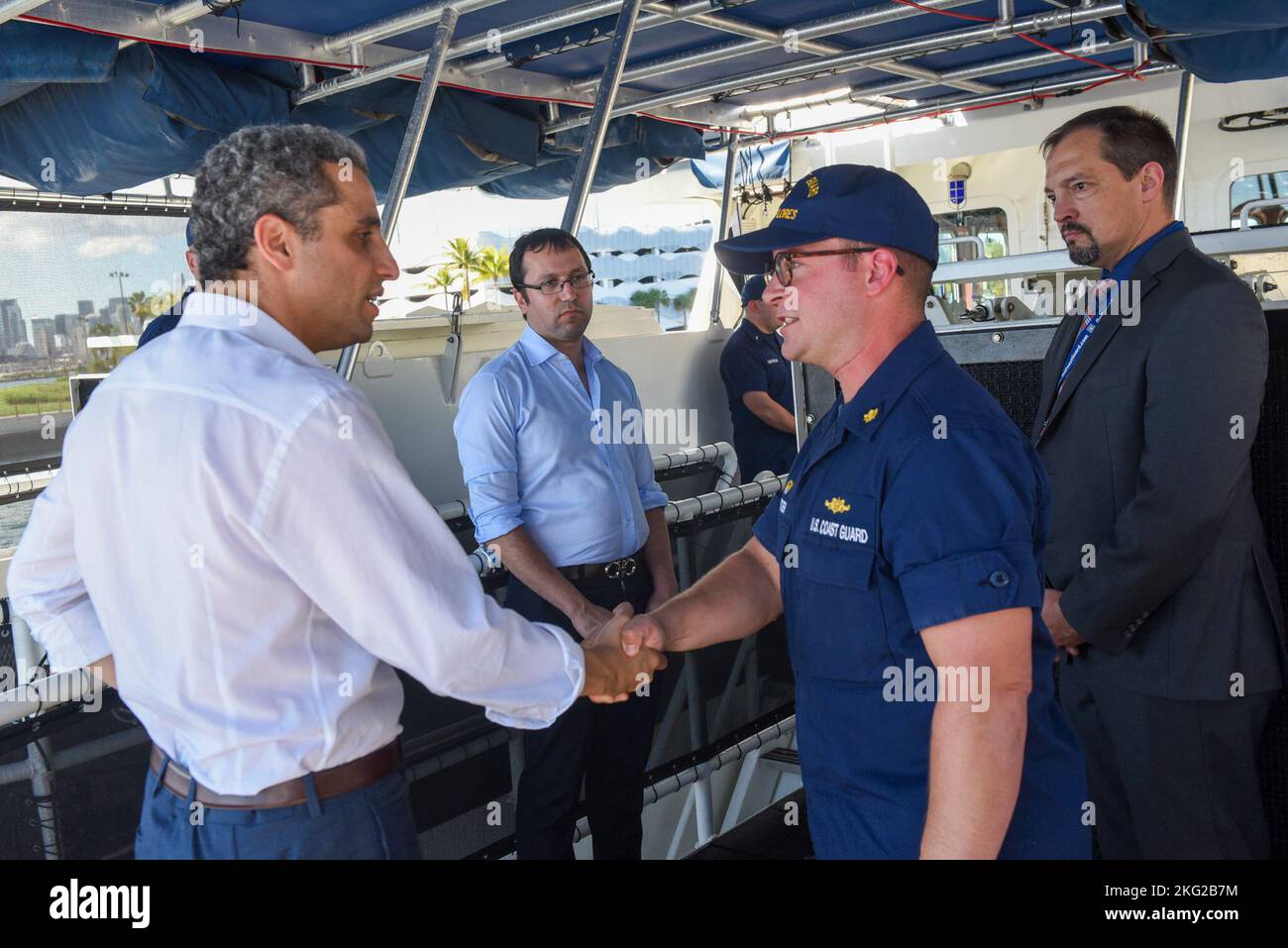 Robert Silvers, Under Secretary for Policy for the Department of Homeland Security is greeted by Lt. Cmdr. Ryan Webster, commanding officer of the Coast Guard Cutter William Flores, at Coast Guard Base Miami Beach, Oct. 25, 2022. The purpose of Under Secretary Silvers’ visit was to discuss lines of effort including readiness, partnership efforts within migrant operations and counter drug missions in the Caribbean and Florida region. Stock Photo